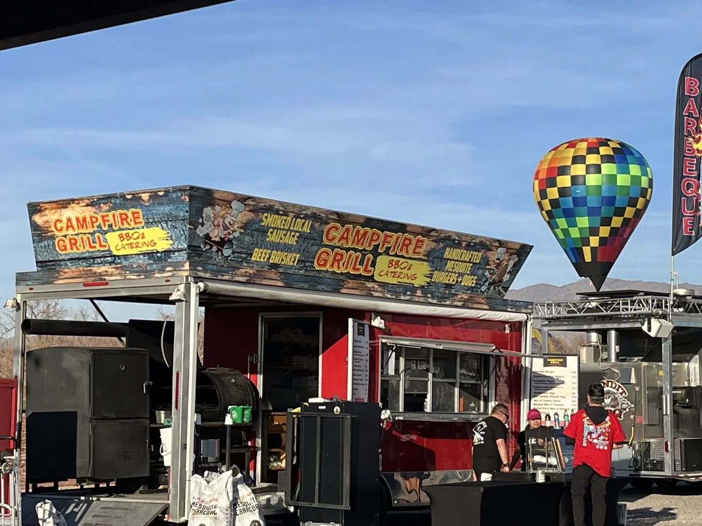 Campfire Grill truck at an event with hot air balloon in the background