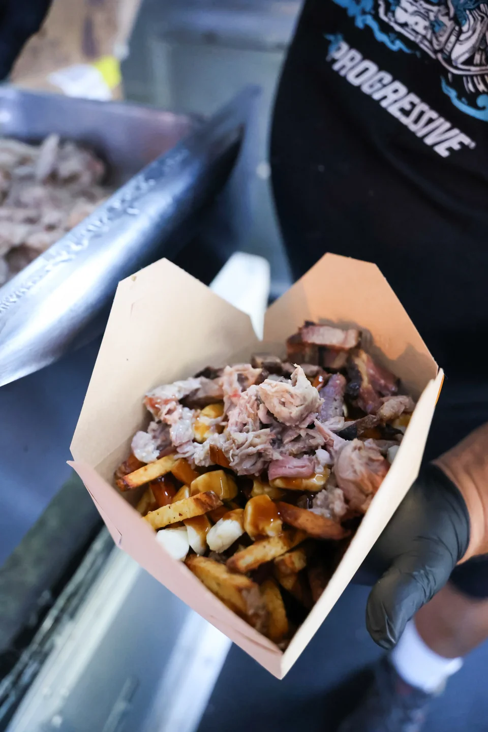 Pulled pork poutine in a kraft takeout box