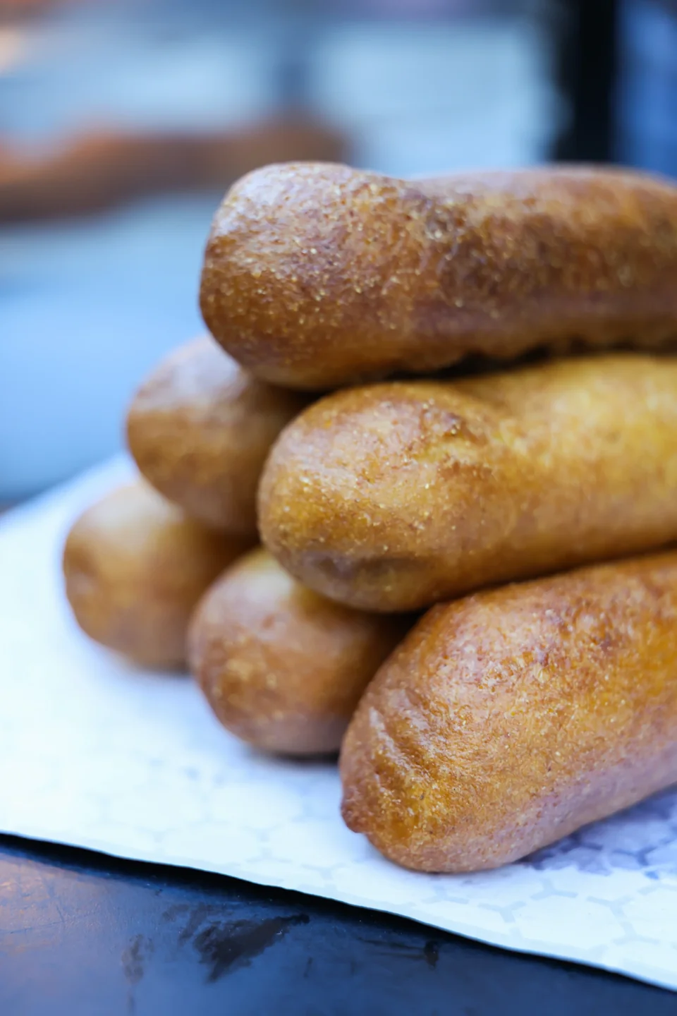 Stack of golden hand-dipped corndogs fresh from the fryer