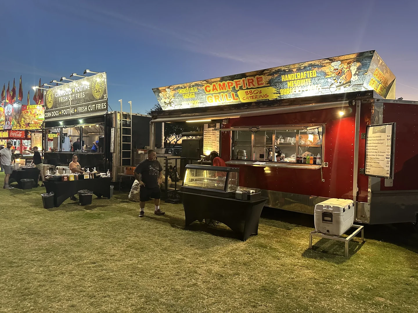 Both Sixon trucks parked on grass at a nighttime event