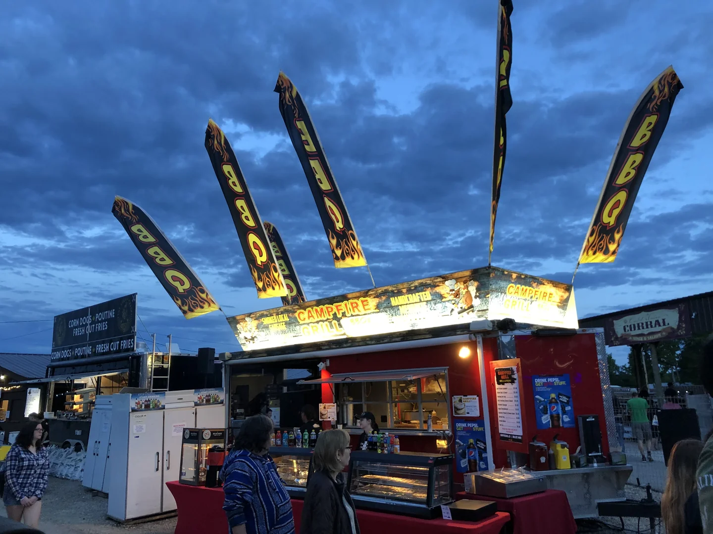 Campfire Grill truck with American flags at a nighttime event