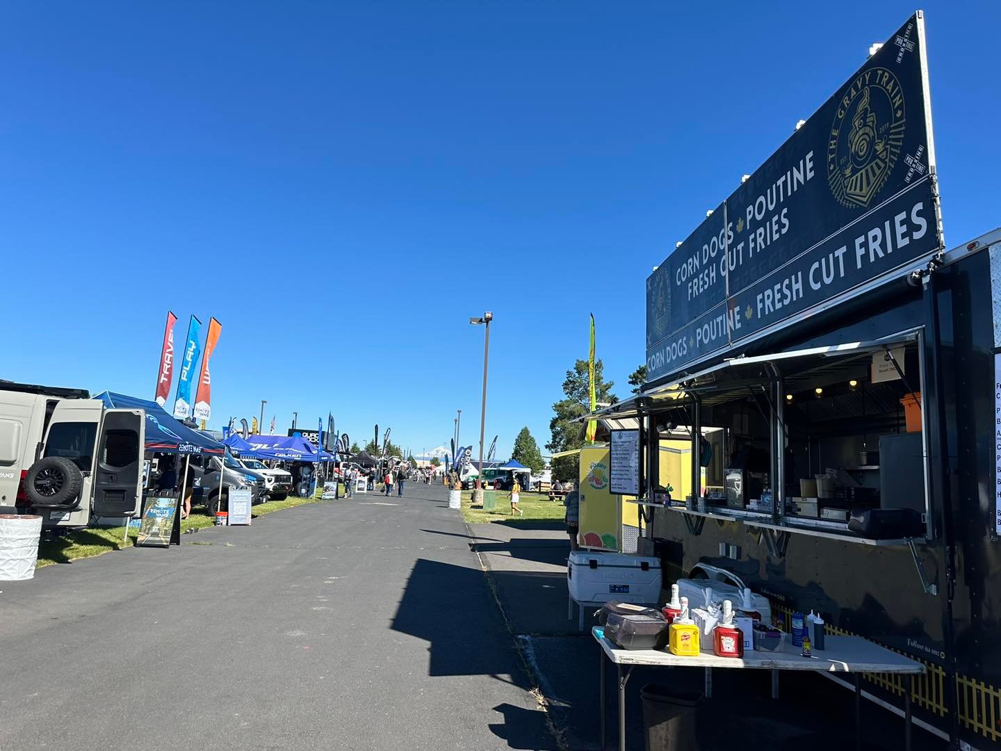 The Gravy Train serving at Overland Expo alongside overlanding rigs and vendors