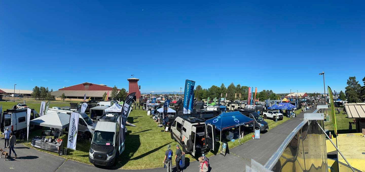 Overland Expo grounds with vendors and overlanding rigs