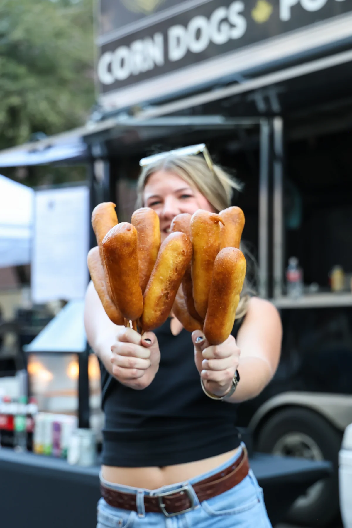 Corn dogs held up in front of The Gravy Train truck